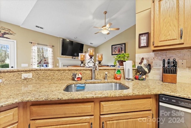 kitchen featuring decorative backsplash, stainless steel dishwasher, ceiling fan, sink, and lofted ceiling