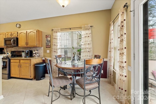 dining space featuring light tile patterned flooring