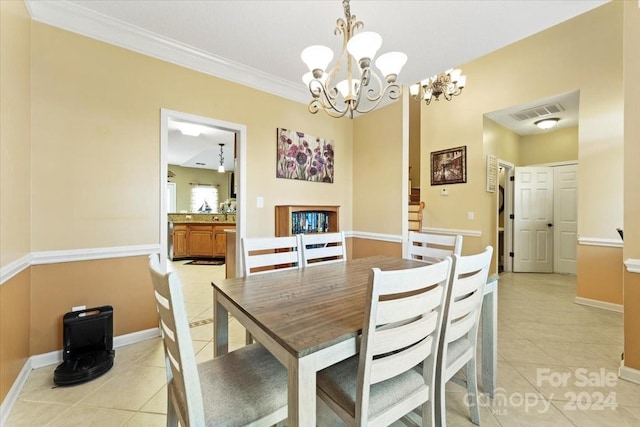 dining space featuring crown molding, light tile patterned floors, and a chandelier