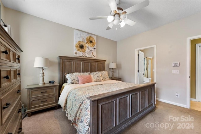 bedroom featuring ensuite bath, ceiling fan, and light colored carpet