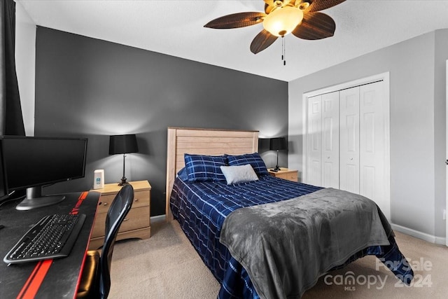 bedroom with a closet, ceiling fan, and light colored carpet