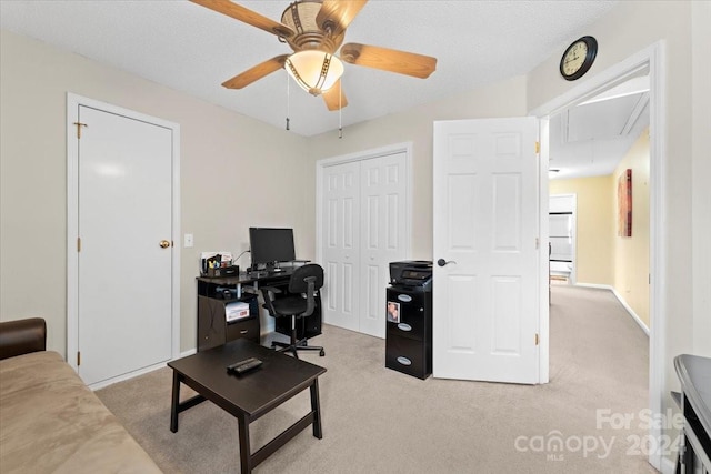 office area featuring ceiling fan and light carpet