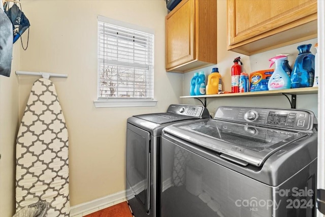 laundry room with cabinets and separate washer and dryer