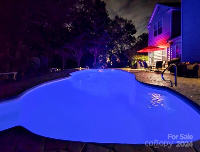 pool at night with a patio