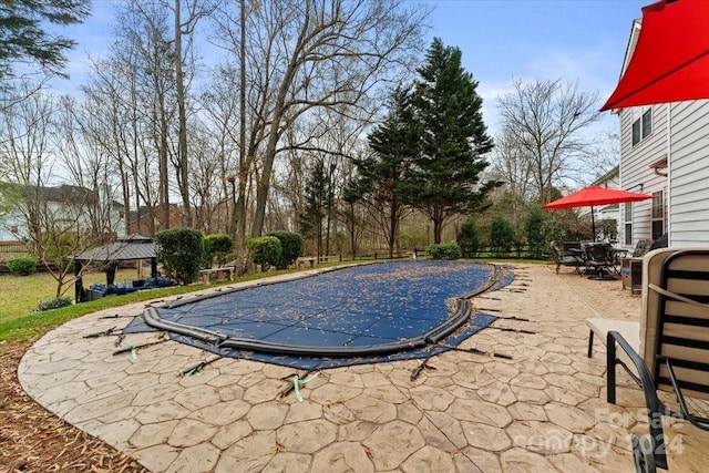 view of pool featuring a gazebo and a patio