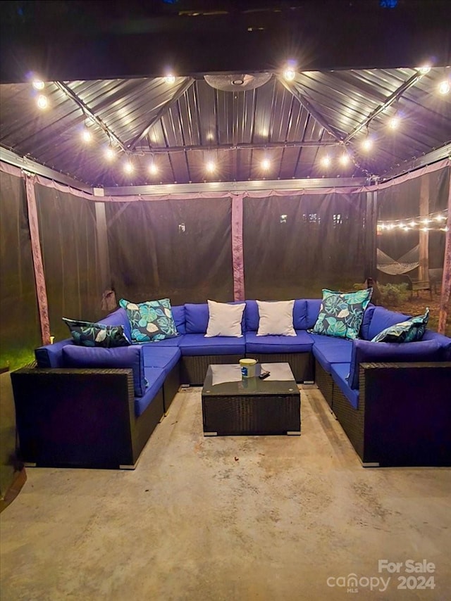 home theater room featuring concrete floors and track lighting