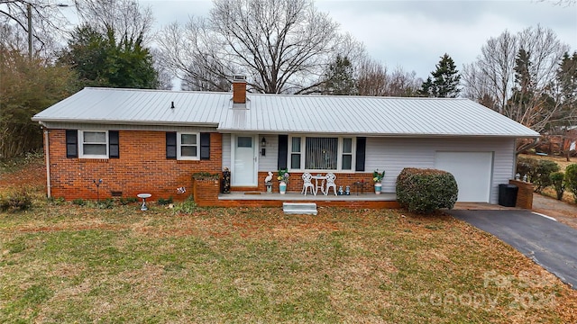 ranch-style home with covered porch, a garage, and a front lawn