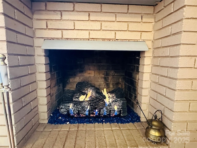 room details with a brick fireplace and wood finished floors