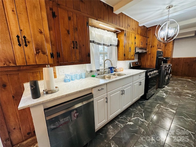 kitchen with a sink, marble finish floor, stainless steel appliances, wood walls, and beam ceiling