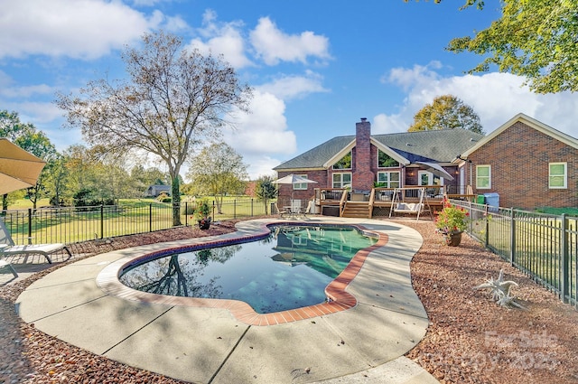 view of swimming pool featuring a wooden deck