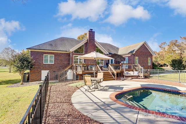 view of swimming pool with a patio area, a yard, and a deck