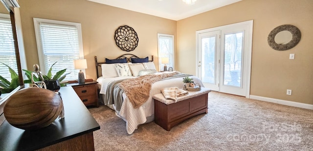 bedroom with light colored carpet and access to outside