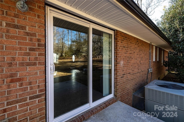 doorway to property featuring central AC