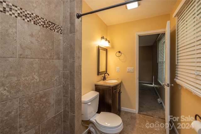 bathroom featuring tile patterned floors, vanity, and toilet