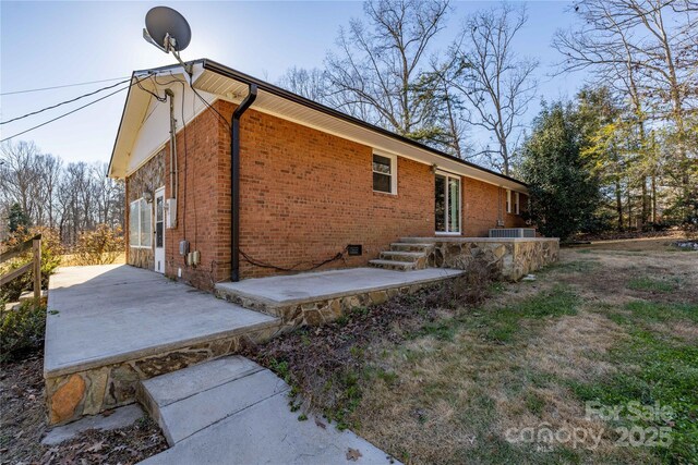 206 Fox Den Rd, Troy, NC 27371 - view of property exterior with a patio area and brick siding