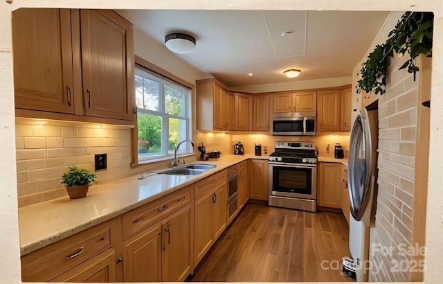 206 Fox Den Rd, Troy, NC 27371 - kitchen featuring appliances with stainless steel finishes, wood finished floors, tasteful backsplash, and light stone counters
