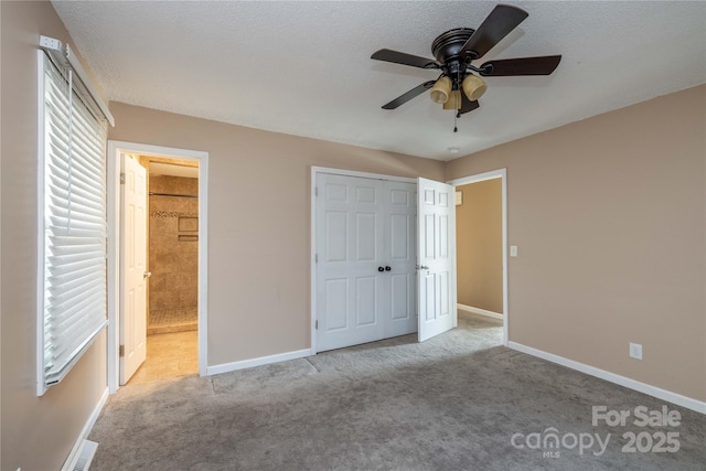 206 Fox Den Rd, Troy, NC 27371 - unfurnished bedroom featuring carpet flooring, ensuite bath, a closet, and a ceiling fan