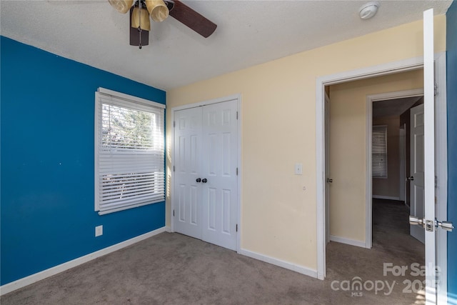 206 Fox Den Rd, Troy, NC 27371 - unfurnished bedroom featuring carpet floors, a closet, and a ceiling fan
