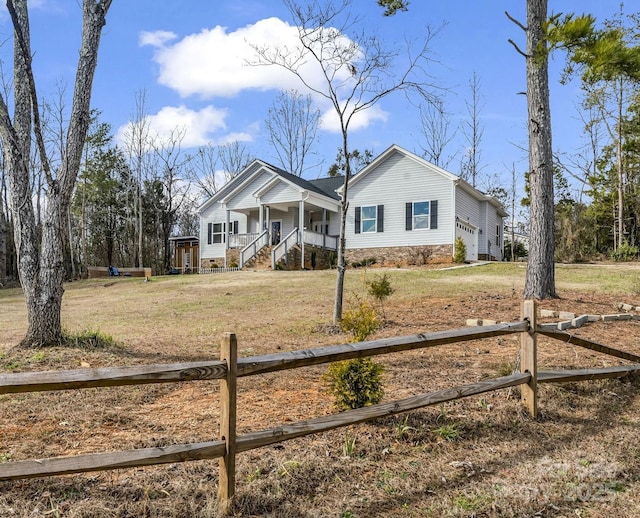 view of front of house with a front yard and covered porch