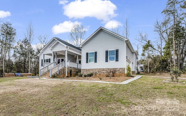 view of front of property with covered porch and a front lawn