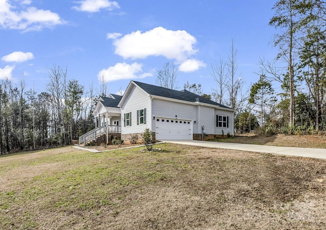 view of side of property featuring driveway, a lawn, and an attached garage