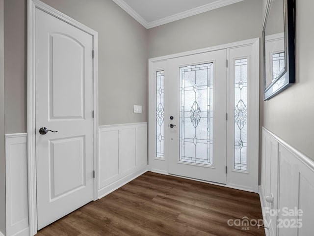 foyer with ornamental molding, wainscoting, and dark wood-style floors