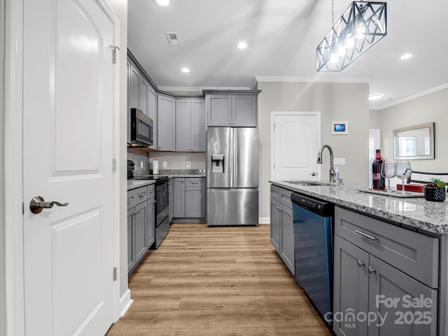 kitchen featuring gray cabinets, stainless steel appliances, and a sink