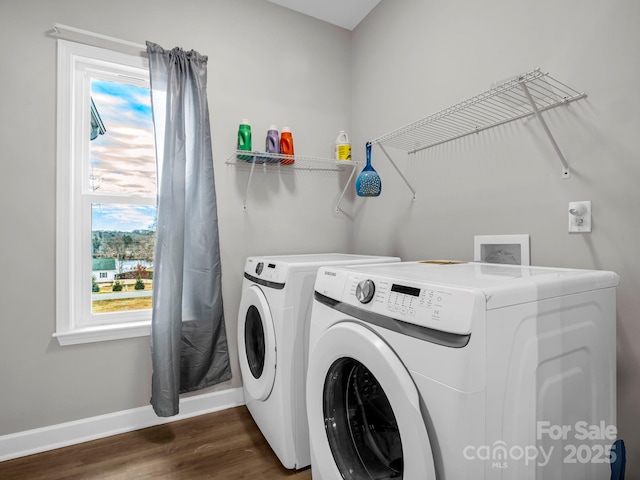 washroom with dark wood-type flooring, laundry area, washer and clothes dryer, and baseboards