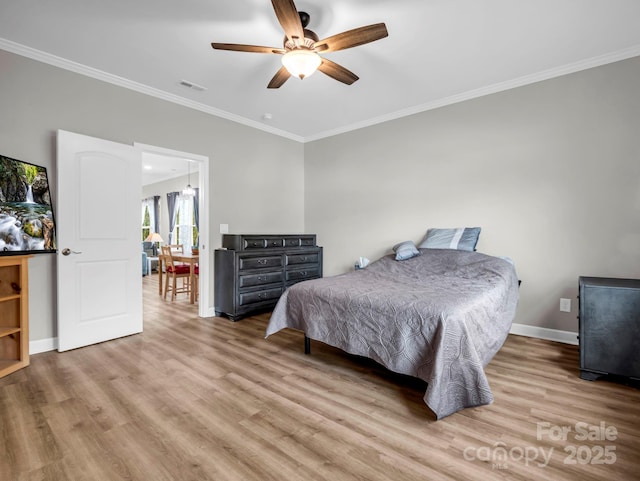 bedroom featuring crown molding, light wood-type flooring, and ceiling fan