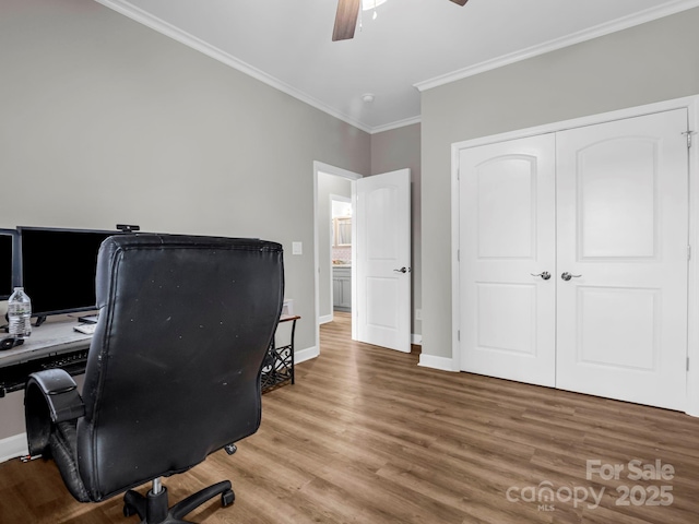 office area featuring ornamental molding, wood-type flooring, and ceiling fan