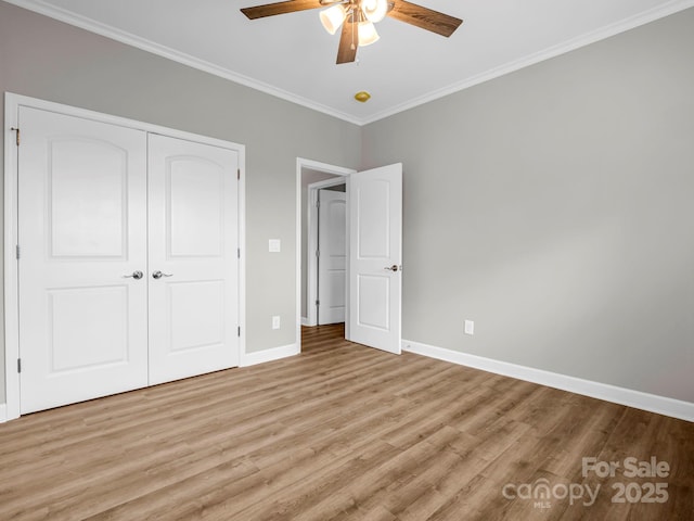 unfurnished bedroom with light hardwood / wood-style flooring, ornamental molding, a closet, and ceiling fan