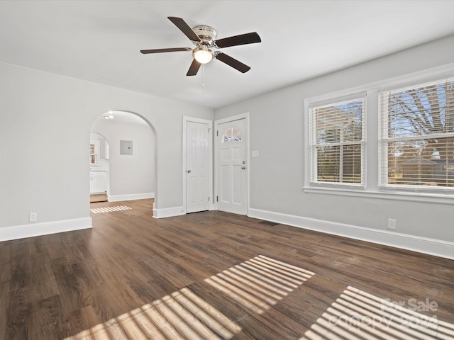 unfurnished room with ceiling fan and dark hardwood / wood-style flooring