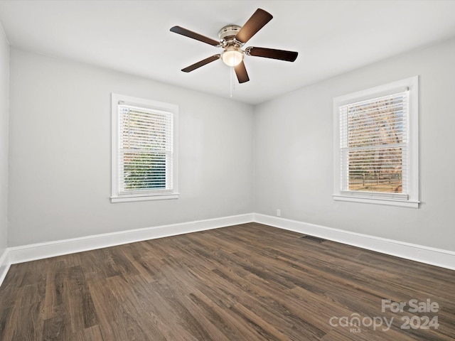 spare room featuring dark hardwood / wood-style floors and ceiling fan