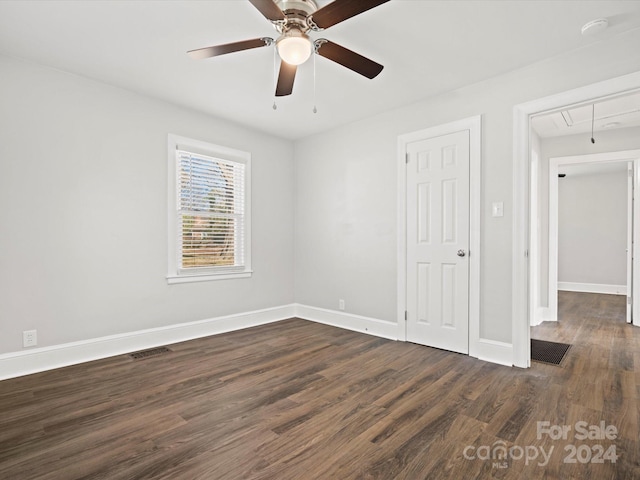 unfurnished room featuring ceiling fan and dark hardwood / wood-style flooring