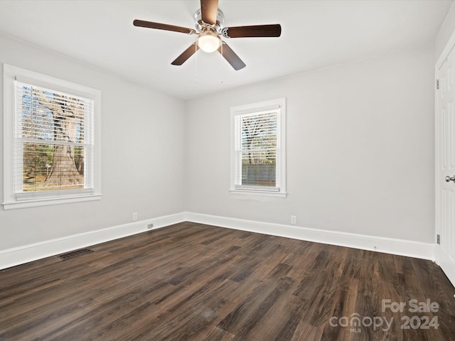 spare room featuring ceiling fan and dark hardwood / wood-style flooring