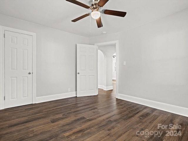 spare room featuring ceiling fan and dark hardwood / wood-style floors