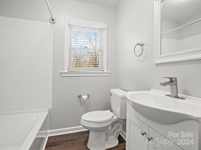 full bathroom featuring bathtub / shower combination, vanity, hardwood / wood-style flooring, and toilet