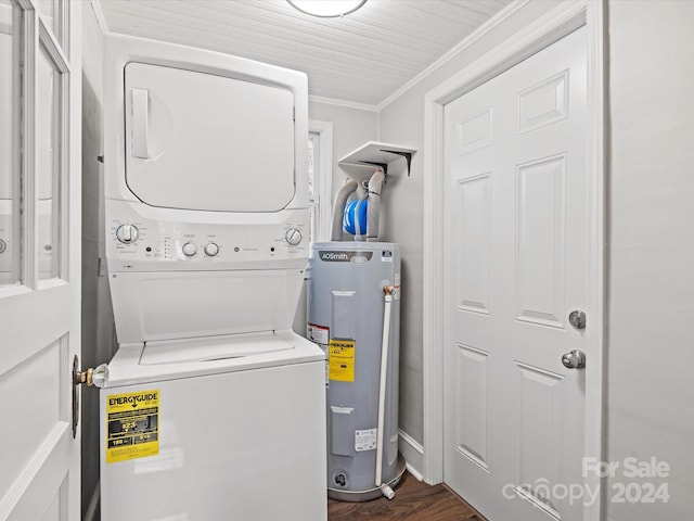 laundry room with dark wood-type flooring, electric water heater, stacked washer and dryer, and ornamental molding