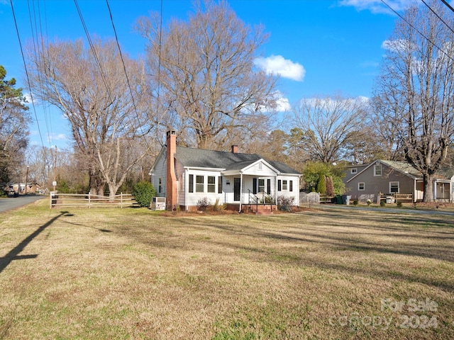 ranch-style home featuring a porch and a front lawn