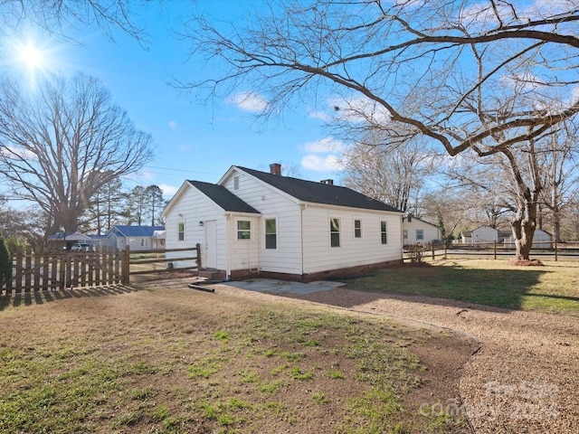 view of side of home with a lawn