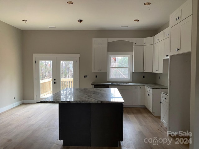 kitchen with a kitchen island, white cabinetry, and french doors