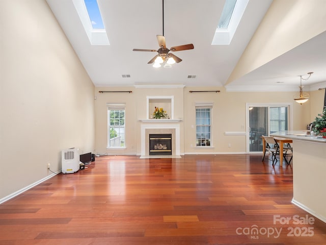 9903 Southampton Commons Dr, Charlotte, NC 28277 - unfurnished living room featuring a skylight, high vaulted ceiling, a fireplace with flush hearth, ceiling fan, and wood finished floors