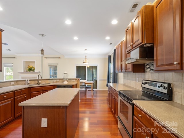 9903 Southampton Commons Dr, Charlotte, NC 28277 - kitchen featuring stainless steel electric range, ornamental molding, light countertops, backsplash, and dark wood finished floors