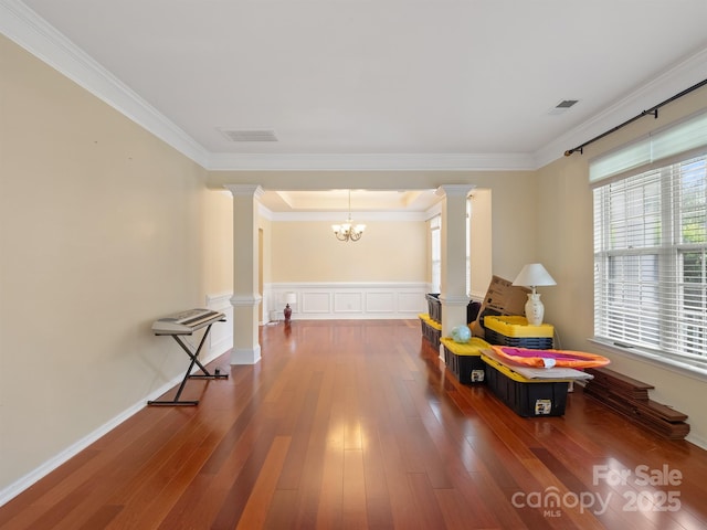 9903 Southampton Commons Dr, Charlotte, NC 28277 - sitting room featuring ornate columns, a chandelier, ornamental molding, and wood finished floors