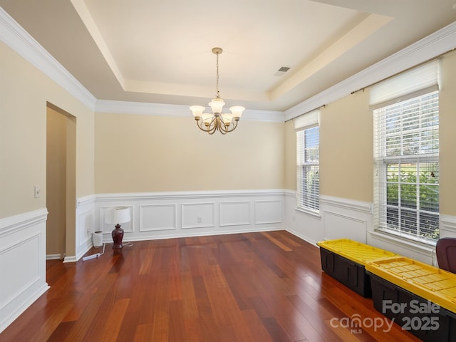 9903 Southampton Commons Dr, Charlotte, NC 28277 - unfurnished dining area with a tray ceiling, a chandelier, wood finished floors, and a wainscoted wall