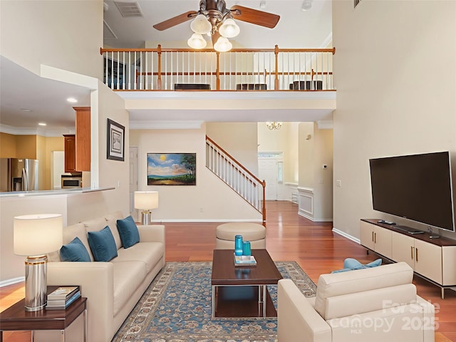 9903 Southampton Commons Dr, Charlotte, NC 28277 - living area featuring a high ceiling, a ceiling fan, stairway, and wood finished floors