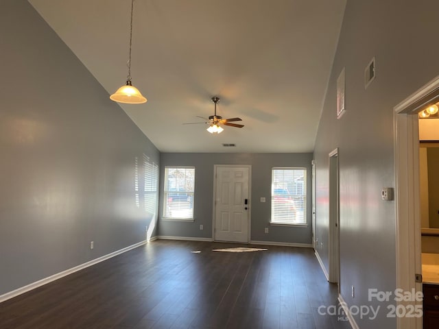 foyer entrance with a healthy amount of sunlight, high vaulted ceiling, ceiling fan, and dark wood-type flooring