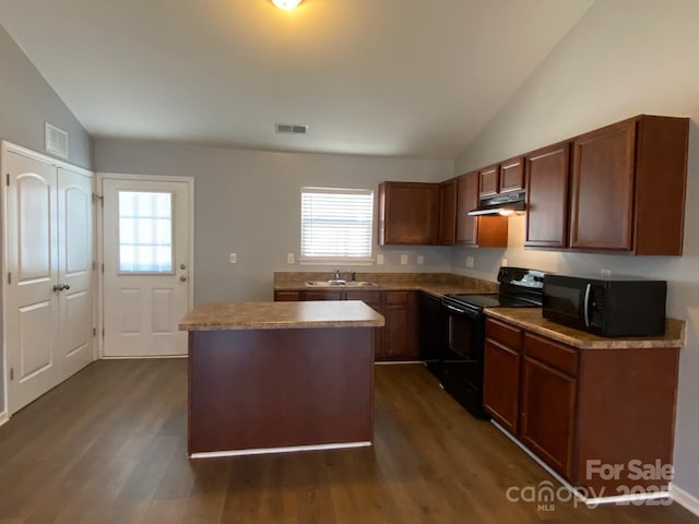 kitchen with sink, dark hardwood / wood-style flooring, vaulted ceiling, a kitchen island, and black appliances