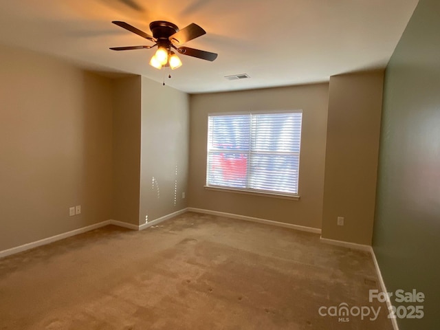 carpeted spare room with ceiling fan