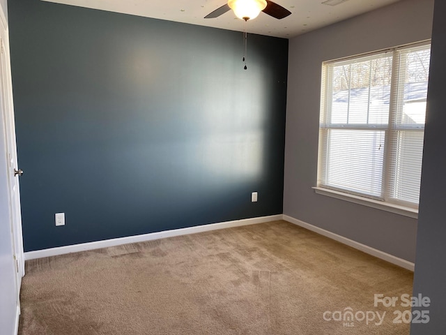 unfurnished room featuring light carpet and ceiling fan